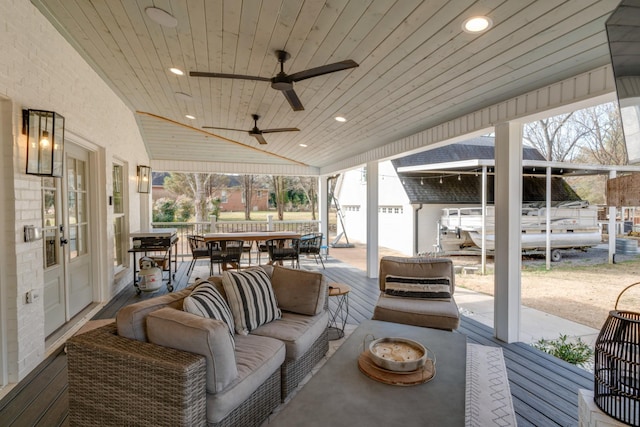 view of patio / terrace with an outdoor living space, outdoor dining area, and ceiling fan
