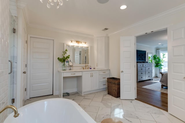 bathroom with a shower stall, a freestanding bath, ornamental molding, marble finish floor, and vanity