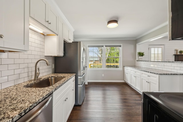 kitchen featuring dark wood finished floors, ornamental molding, a sink, appliances with stainless steel finishes, and backsplash