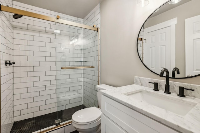 full bathroom with toilet, a stall shower, and vanity