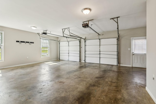 garage with a garage door opener and baseboards