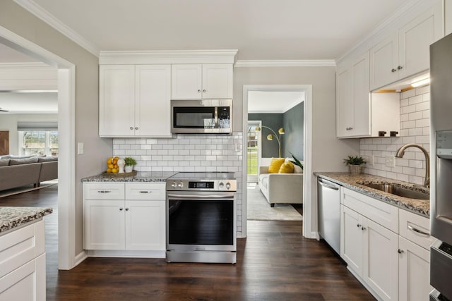 kitchen featuring a sink, appliances with stainless steel finishes, crown molding, light stone countertops, and dark wood-style flooring