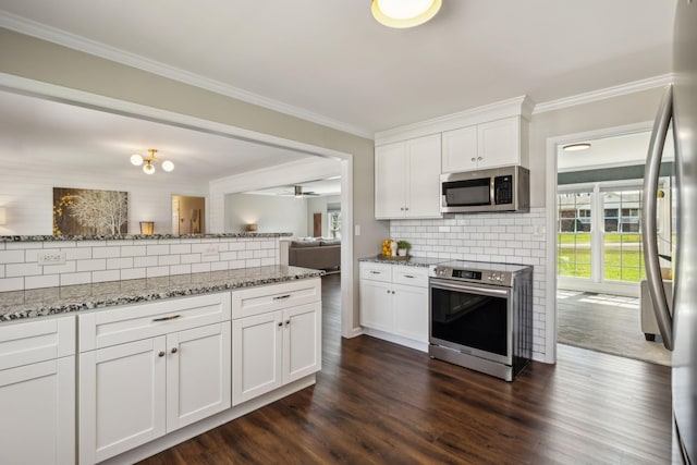 kitchen with ornamental molding, light stone countertops, dark wood-style flooring, and stainless steel appliances