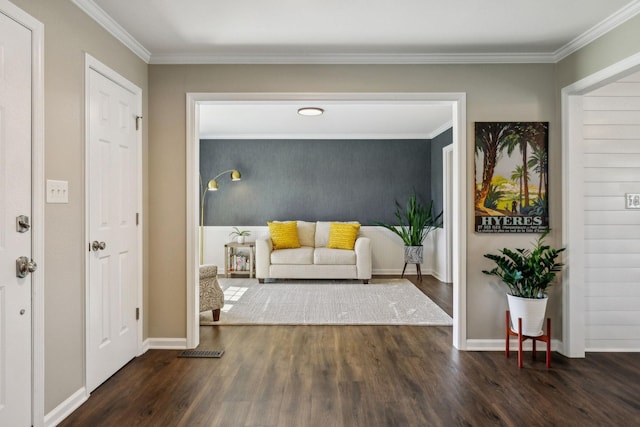 interior space with ornamental molding, baseboards, and wood finished floors