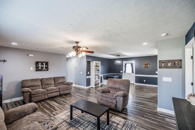 living room featuring wood finished floors, baseboards, and ceiling fan