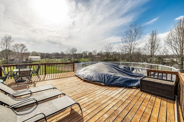 wooden deck featuring outdoor dining area