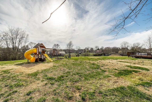 view of play area with a deck and a lawn