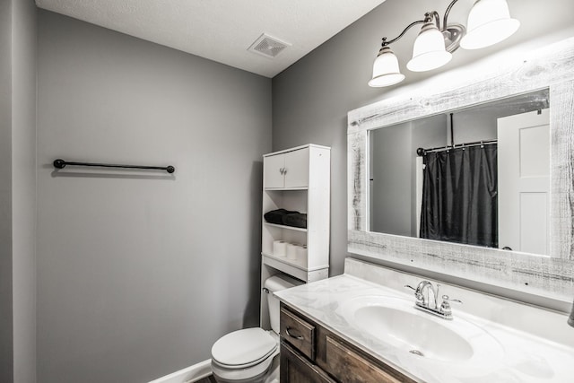 bathroom featuring visible vents, curtained shower, baseboards, toilet, and vanity