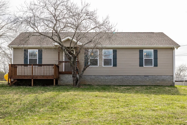 rear view of house with crawl space, a wooden deck, a lawn, and a shingled roof