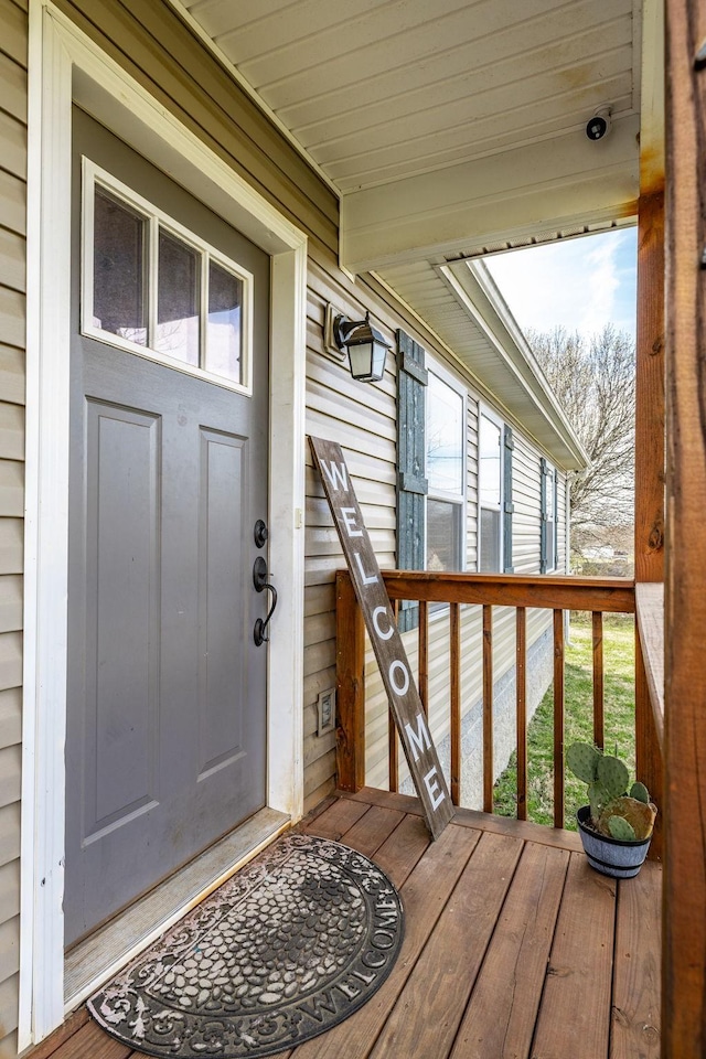 view of exterior entry featuring a deck