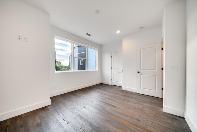 unfurnished bedroom with recessed lighting, visible vents, baseboards, and dark wood-style flooring