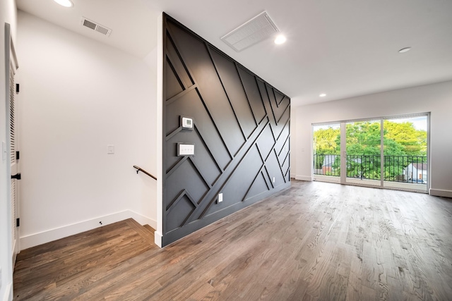 interior space with recessed lighting, wood finished floors, visible vents, and baseboards