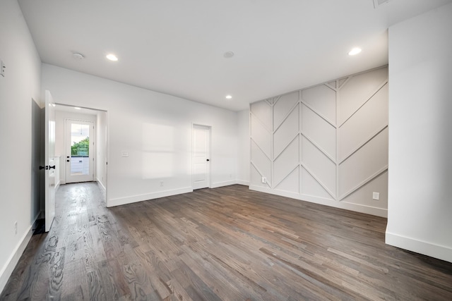 empty room with recessed lighting, baseboards, and wood finished floors