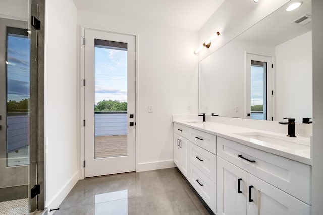 full bathroom featuring double vanity, baseboards, visible vents, and a sink