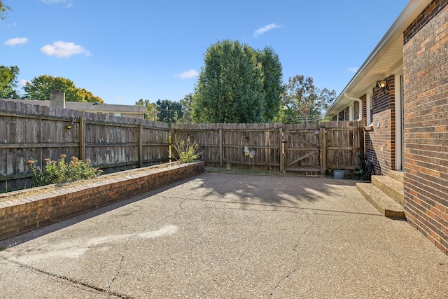 view of patio with a gate and fence