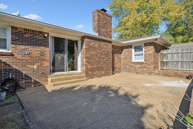 view of patio / terrace featuring entry steps and fence