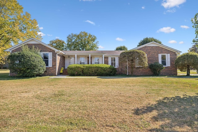 ranch-style home with brick siding and a front yard