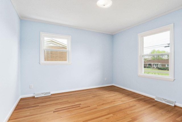 210 Gillen Dr, Sparta, TN 38583 - spare room with crown molding, visible vents, and light wood-type flooring
