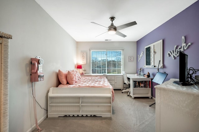 bedroom with a ceiling fan, visible vents, baseboards, and light carpet