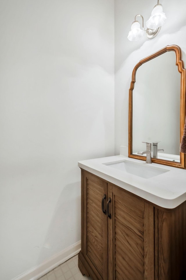 bathroom with tile patterned floors, baseboards, and vanity