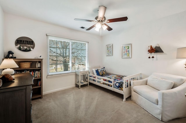 carpeted bedroom featuring visible vents, baseboards, and a ceiling fan