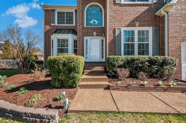 view of exterior entry with brick siding