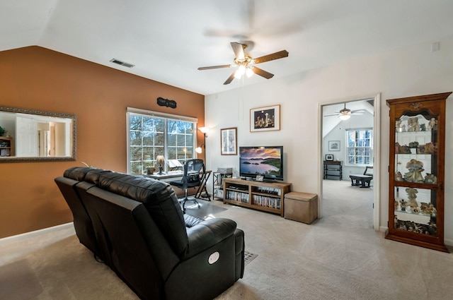 carpeted living area featuring visible vents, lofted ceiling, and ceiling fan