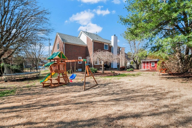 view of play area featuring a storage shed, an outdoor structure, and a trampoline