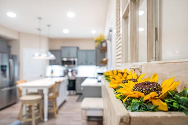 room details with recessed lighting, stainless steel appliances, extractor fan, light countertops, and pendant lighting