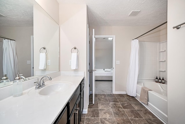 bathroom featuring visible vents, baseboards, vanity, shower / tub combo, and a textured ceiling