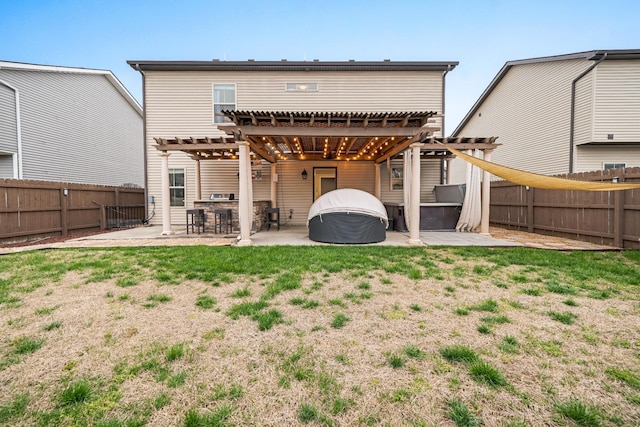 back of house featuring a patio area, a fenced backyard, a jacuzzi, and a pergola