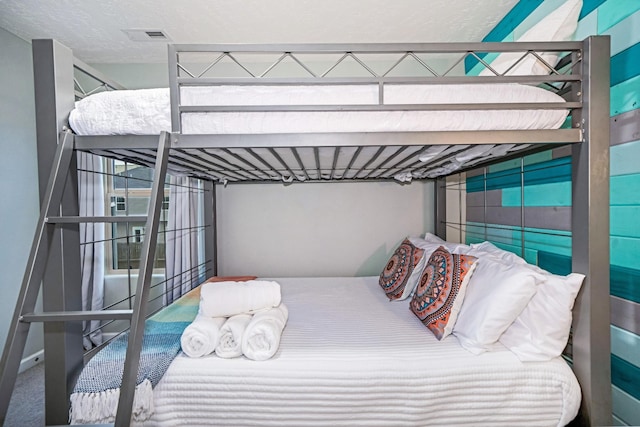 bedroom featuring visible vents and a textured ceiling