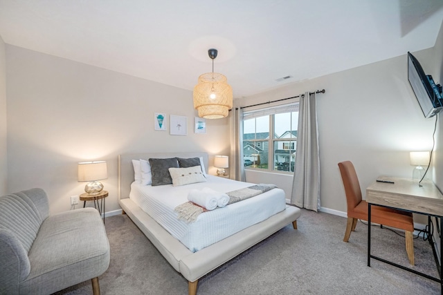 bedroom featuring light carpet, visible vents, and baseboards