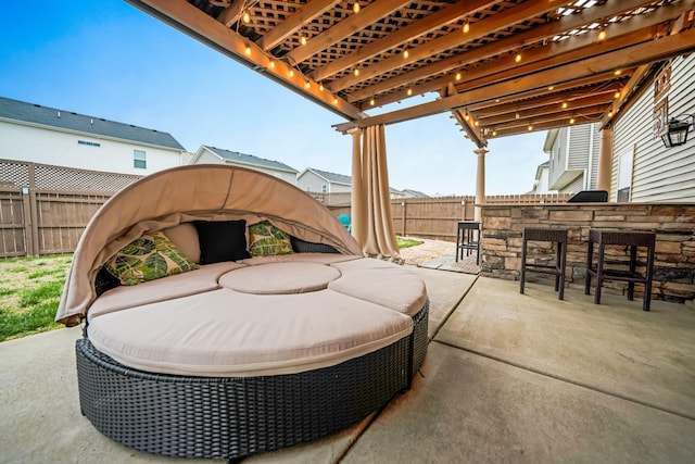 view of patio featuring an outdoor living space, a fenced backyard, outdoor dry bar, and a pergola