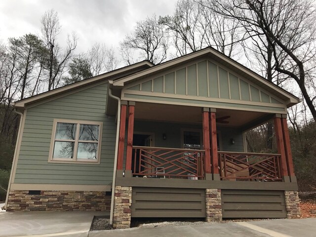 view of front facade with board and batten siding and covered porch