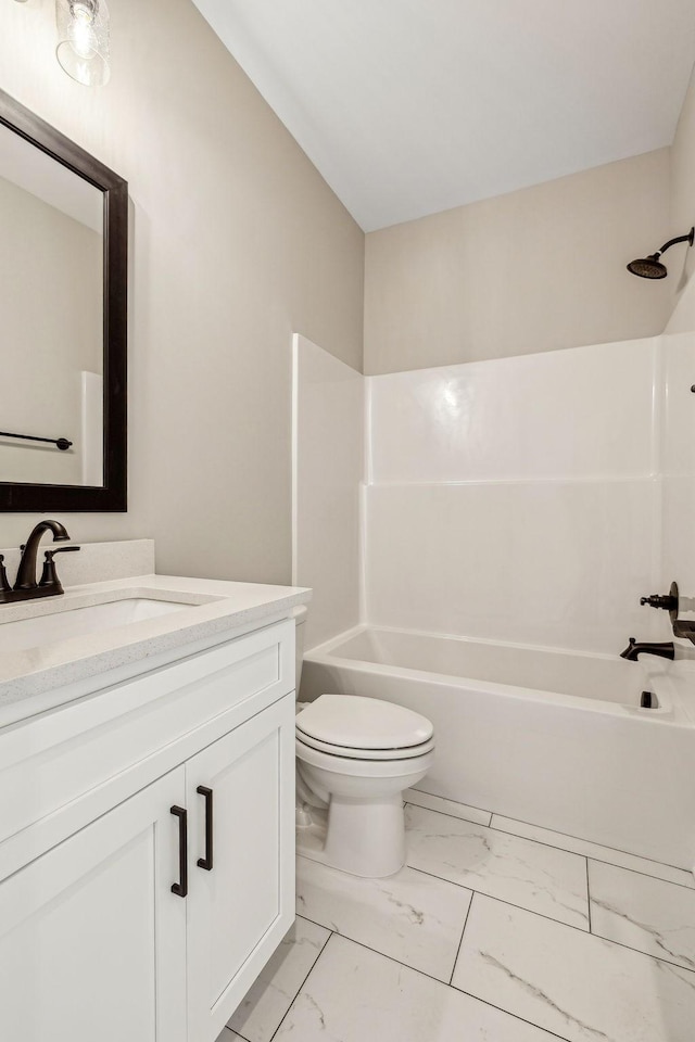 full bathroom featuring toilet, marble finish floor, bathtub / shower combination, and vanity