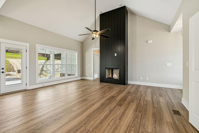 unfurnished living room with wood finished floors, baseboards, visible vents, high vaulted ceiling, and ceiling fan