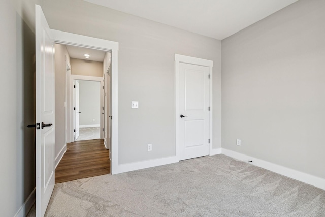 unfurnished bedroom featuring baseboards and carpet flooring