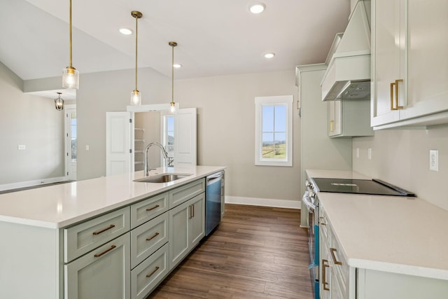 kitchen with light countertops, vaulted ceiling, custom exhaust hood, stainless steel appliances, and a sink