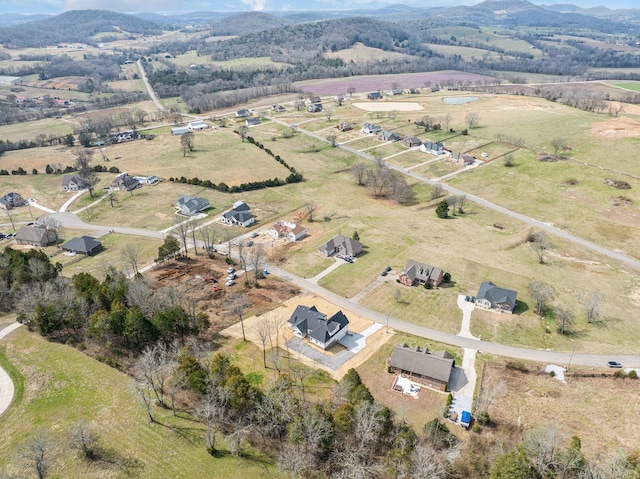 drone / aerial view featuring a rural view and a mountain view