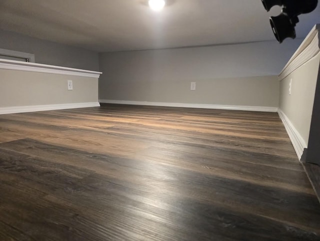 interior space with baseboards and wood finished floors