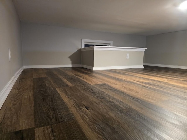 empty room with baseboards and wood finished floors