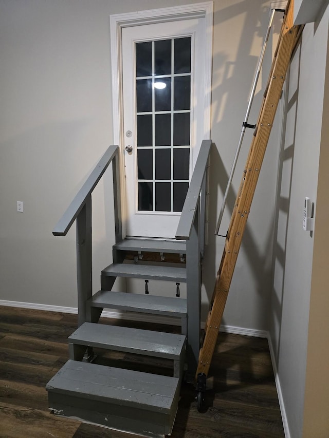 stairway with baseboards and wood finished floors