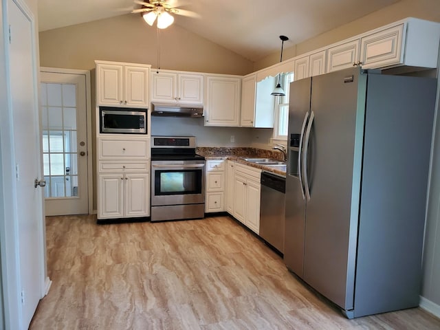 kitchen with a ceiling fan, under cabinet range hood, a sink, stainless steel appliances, and lofted ceiling