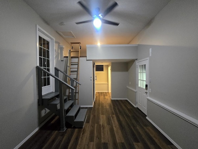 hall with baseboards, a textured ceiling, wood finished floors, and stairs