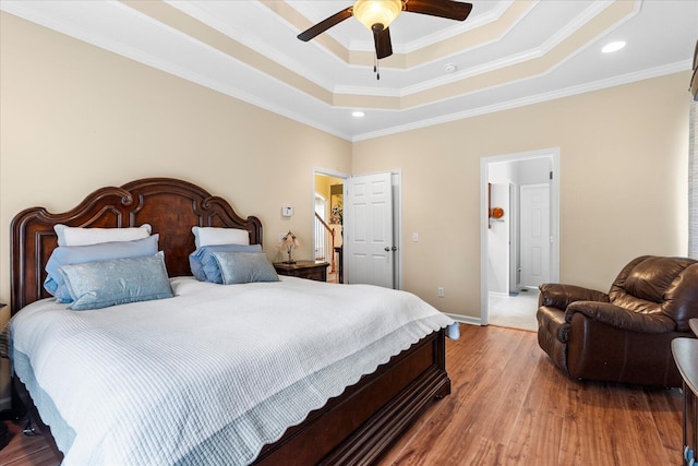 bedroom with baseboards, recessed lighting, a tray ceiling, and light wood-style flooring