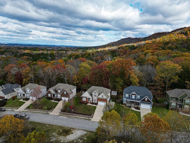 drone / aerial view with a residential view and a wooded view