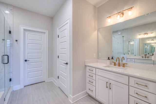 bathroom with vanity, baseboards, and a marble finish shower