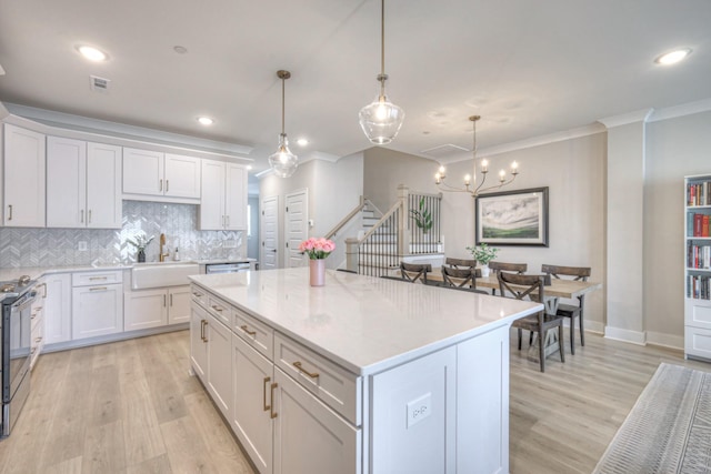 kitchen featuring white cabinetry, electric stove, visible vents, and a sink