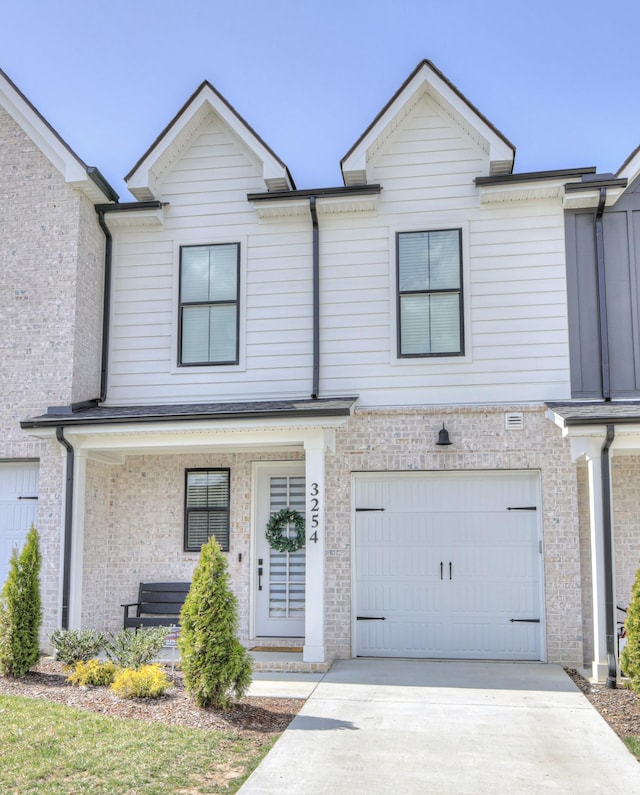 multi unit property with an attached garage and concrete driveway